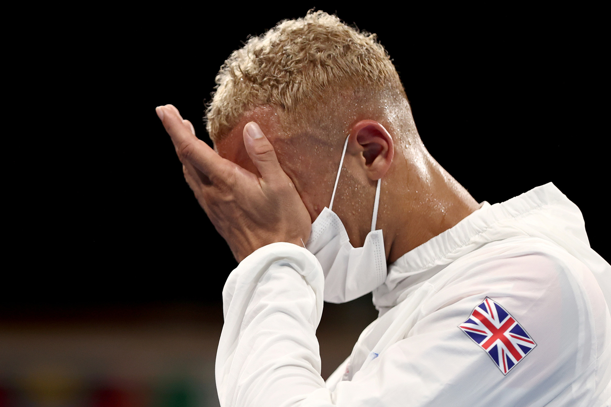 Benjamin Whittaker, British boxer, covers his face with his hands, possibly after a loss or disappointment