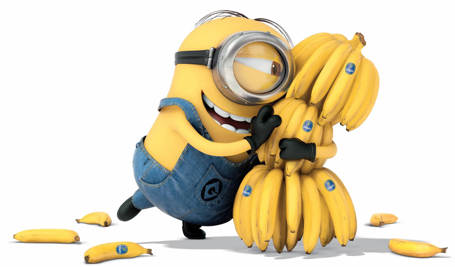 A Minion from Despicable Me happily hugs a bunch of bananas