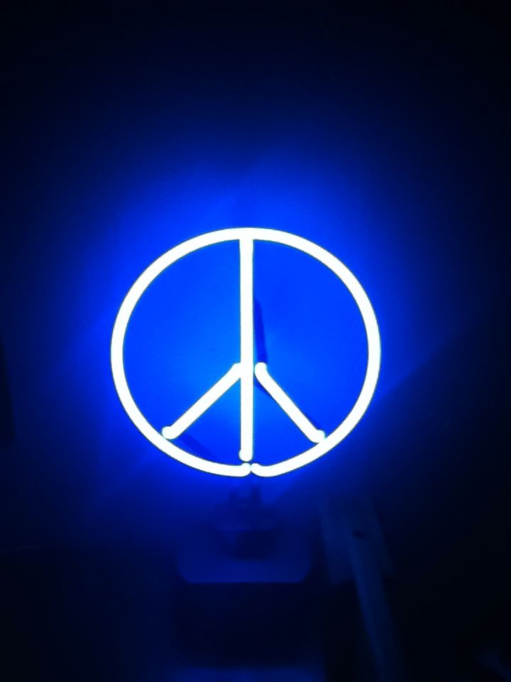 My neon peace sign light that shines in my room every night