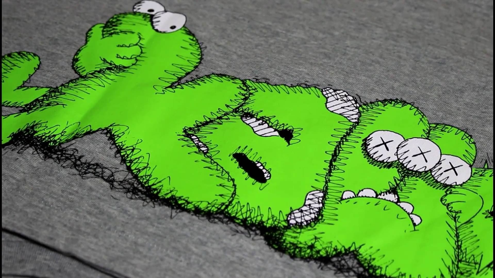 Close-up of a Kaws character printed on a gray fabric, showcasing the vibrant green color and signature design elements