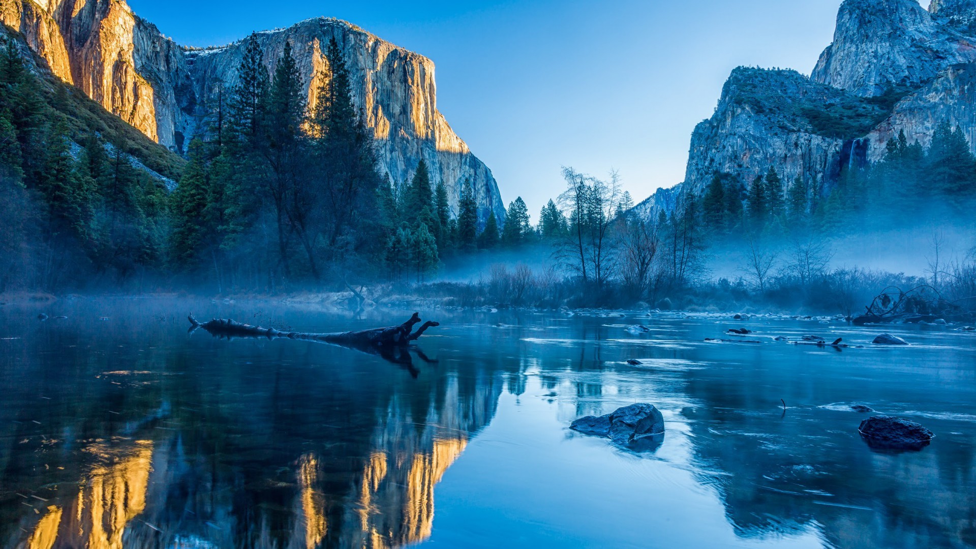 Stunning 5K HD wallpaper of a serene river reflecting majestic cliffs at sunrise in Yosemite National Park