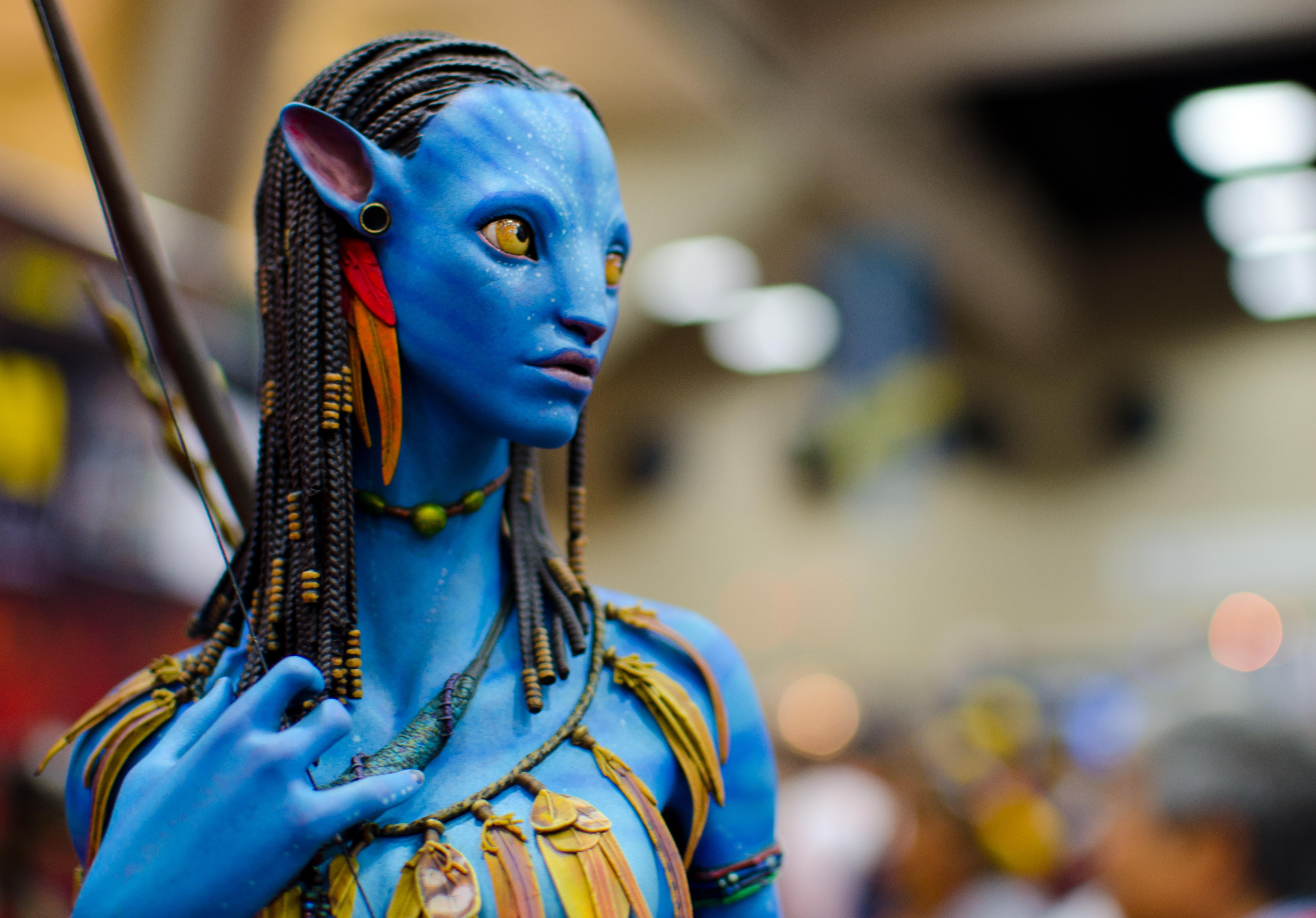 Close-up of a Neytiri action figure from the movie Avatar, showcasing her intricate blue skin, braided hair, and tribal accessories