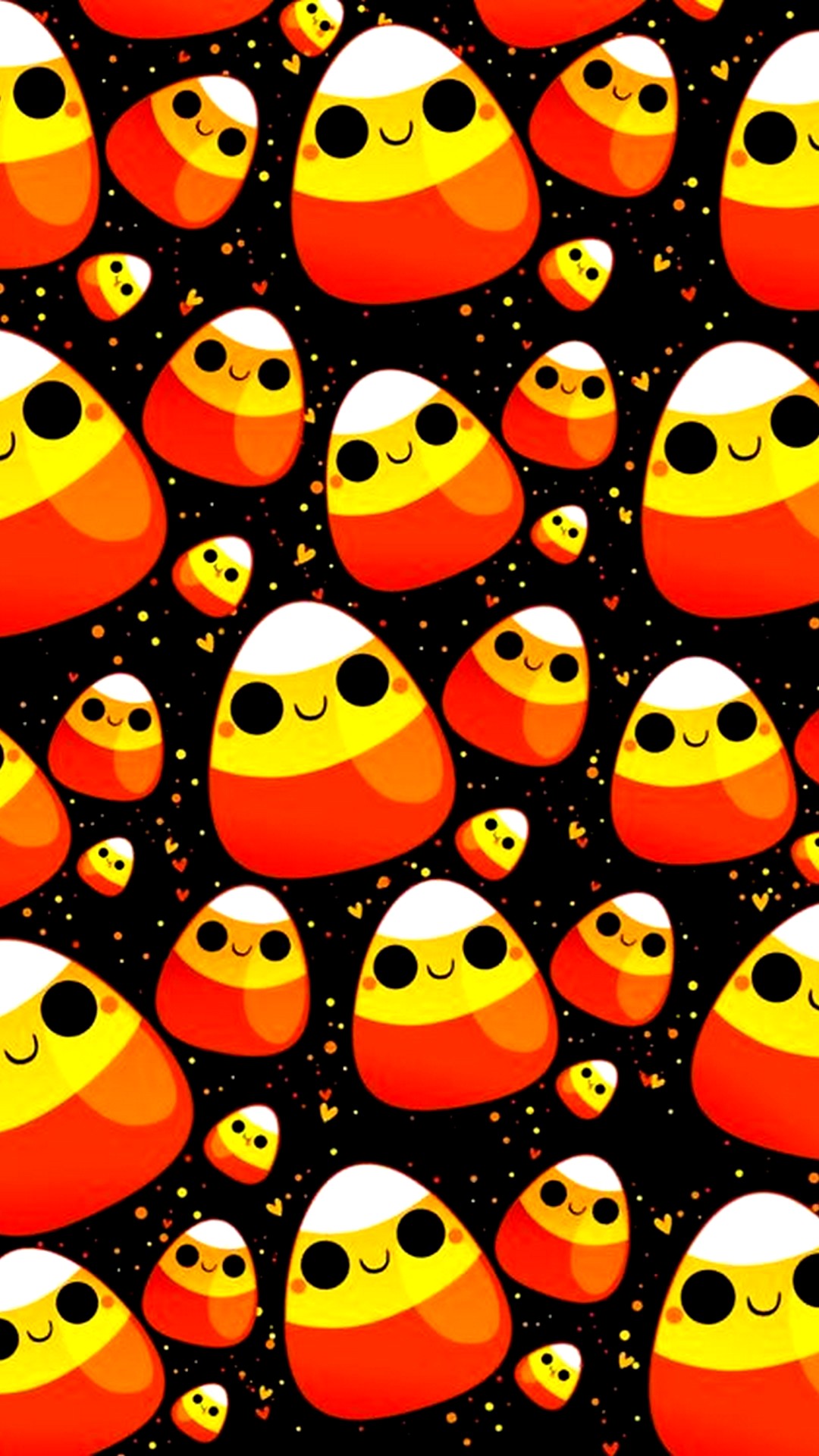 Kawaii candy corn pattern on a black background with orange and yellow polka dots and hearts, perfect for a cute Halloween wallpaper