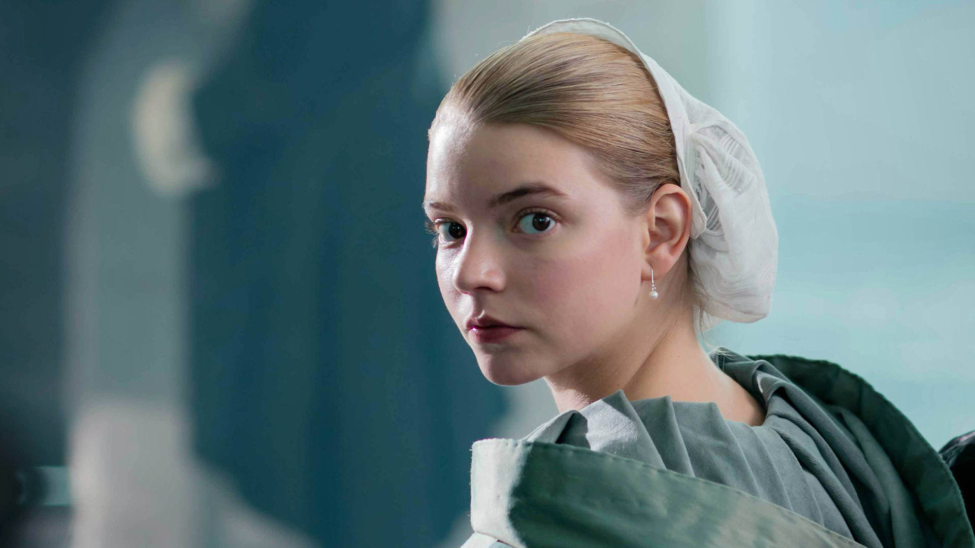 Anya Taylor-Joy in a period costume, looking over her shoulder