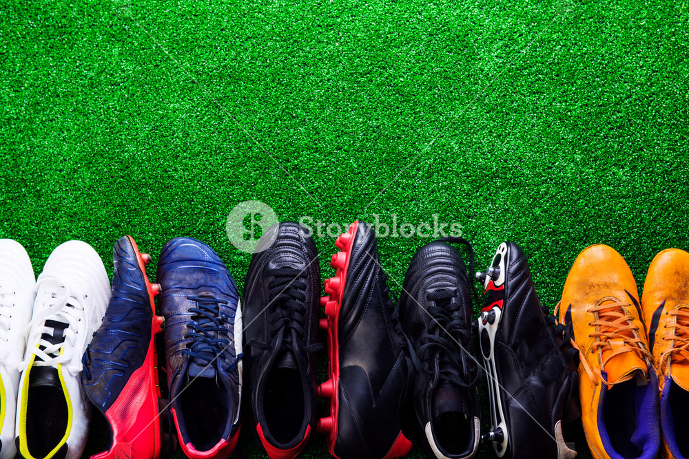 Various Colorful Cleats Against Artificial Turf Studio Shot On