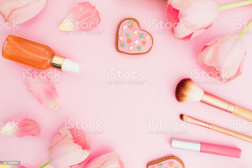 Frame With Tulips Flowers And Cosmetics Cookies On Pink Pastel