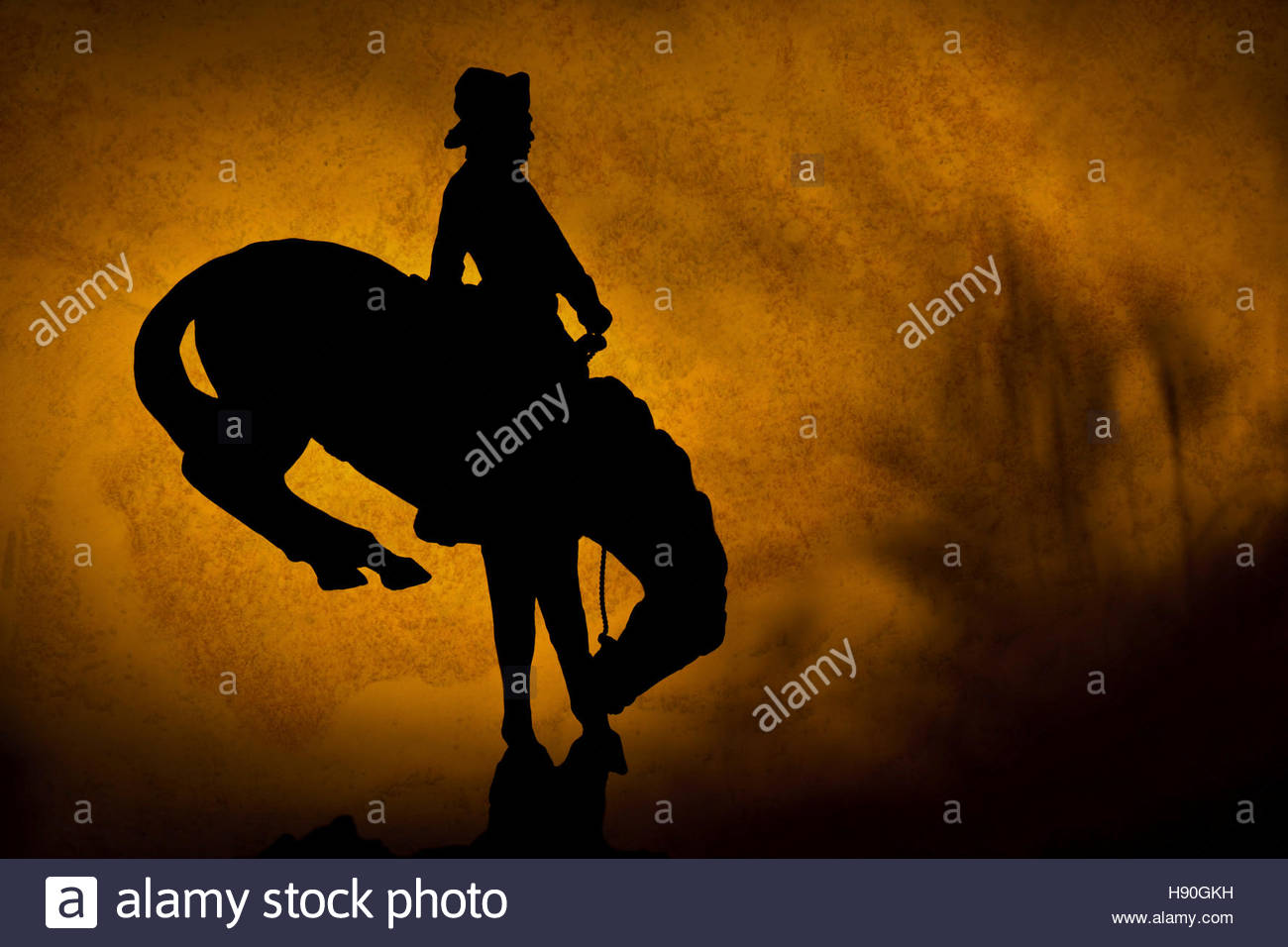 Silhouette Of Cowboy On A Bucking Bronco Orange Yellow Sunset