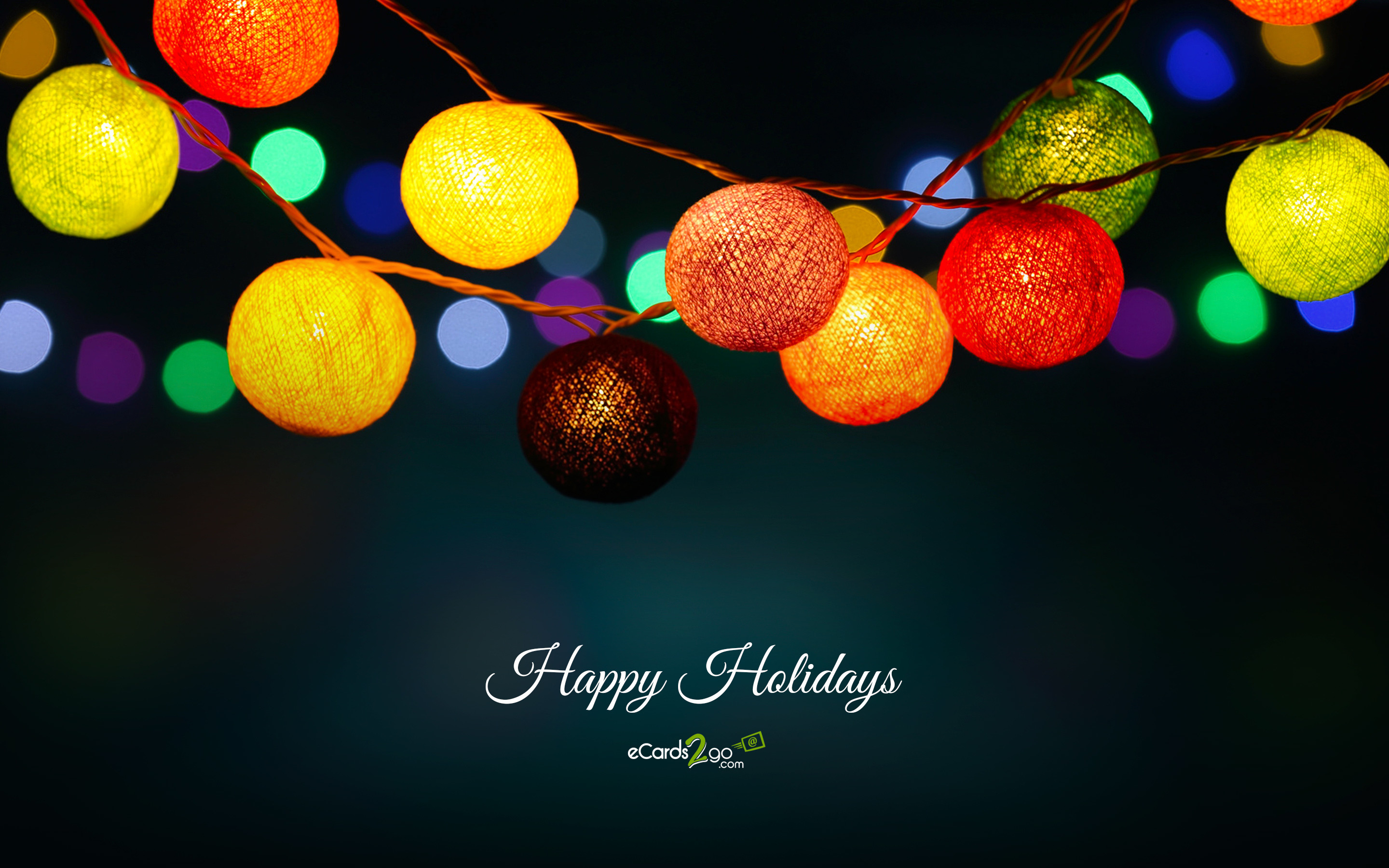 String of colorful Christmas lights against a dark background with bokeh effect