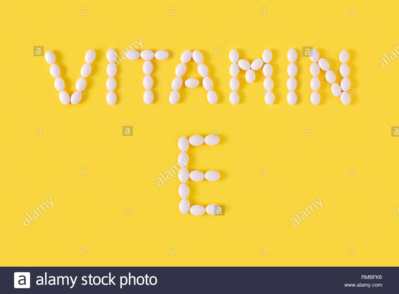 Vitamin E Pills Dropped From Bottle On Yellow Background Flat Lay