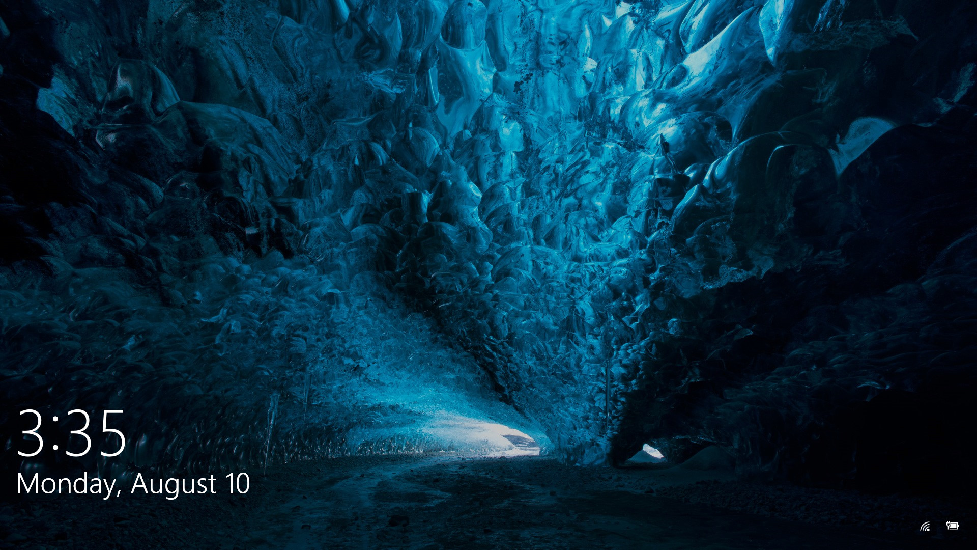 A breathtaking 4K wallpaper of a deep blue ice cave, perfect for Windows 10