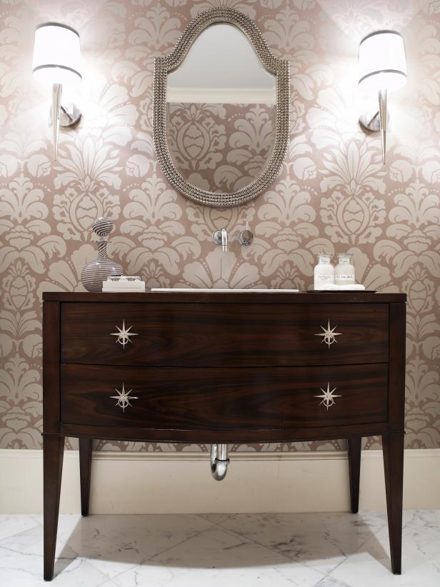 Powder Room With Pale Pink Patterned Wallpaper And Wood Vanity