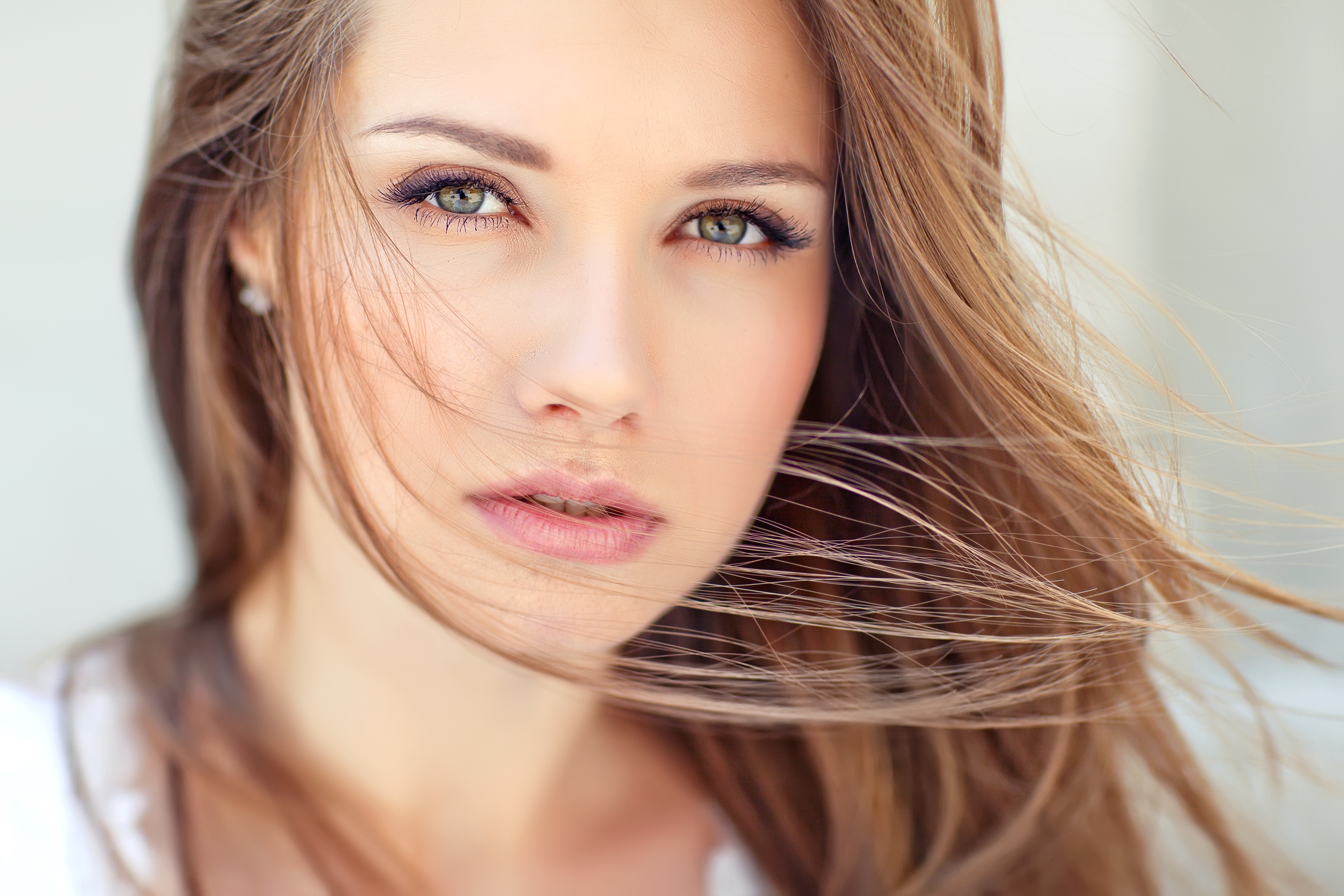 Close-up portrait of a beautiful young woman with long, flowing hair