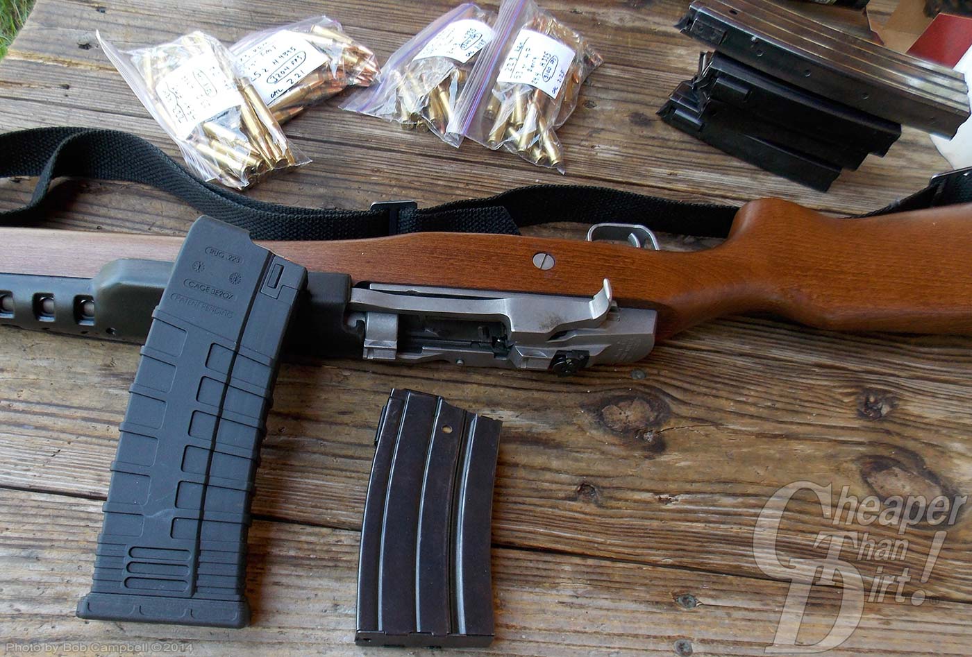Brown Ruger Mini 14 lying on a wooden background