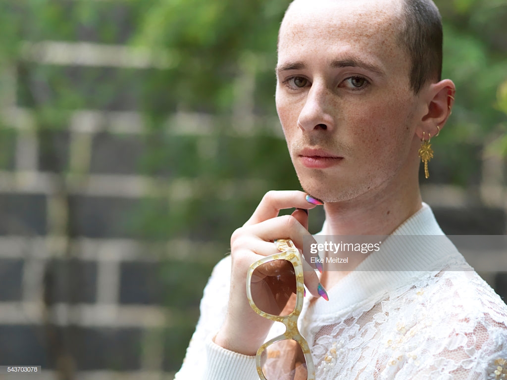 Androgynous Man With Nail Art Holding A Pair Of Sunglasses Stock