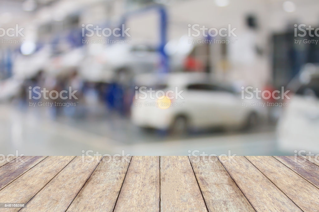 Wood Table Top With Blur Garage Background Stock Photo