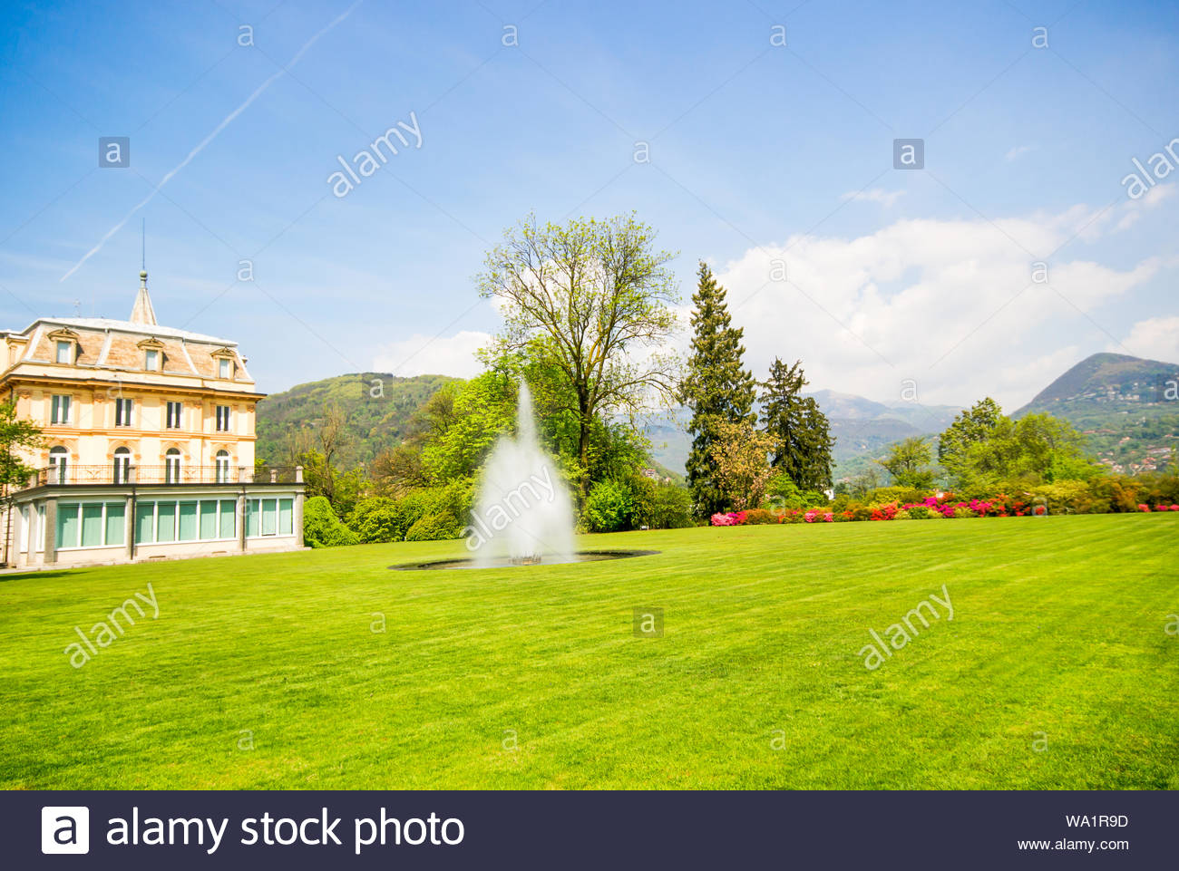 Water Fountain On Green Lawn With Beautiful Villa Background