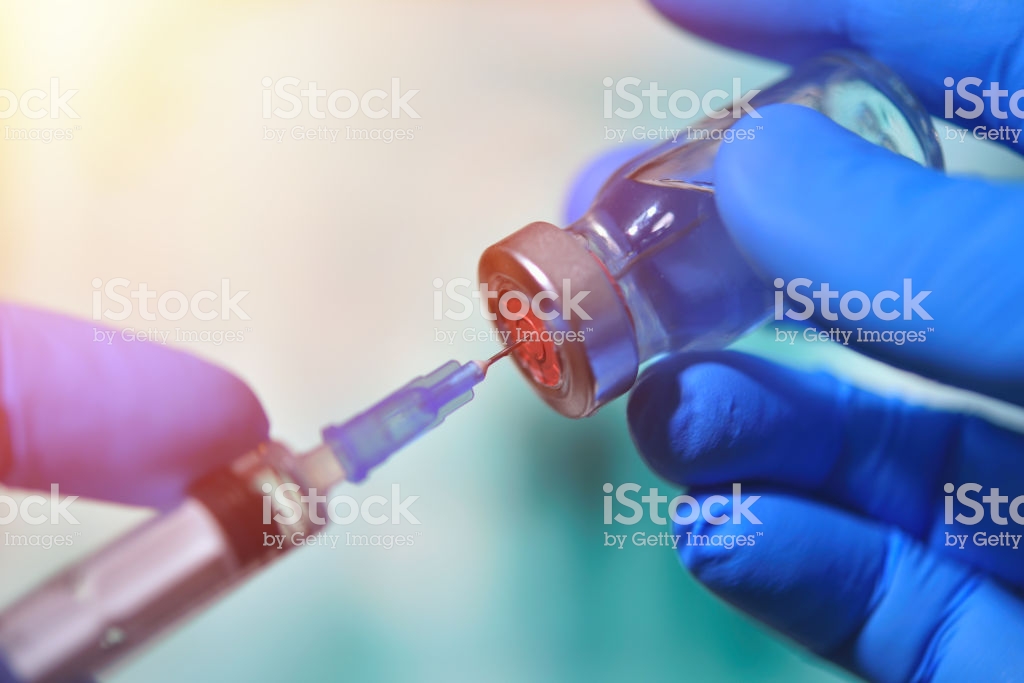 Closeup Of Vaccine Bottle With Syringe And Needle For Immunization