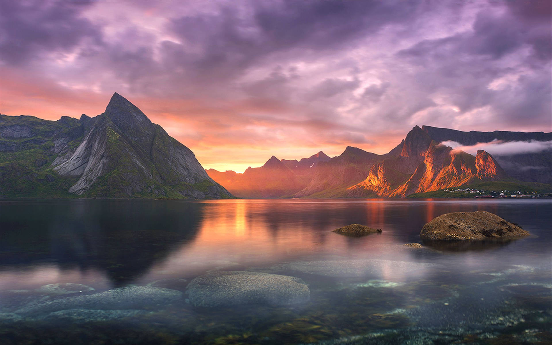 Sunset over a fjord in Norway, with mountains reflecting in the still water, suitable for a MacBook 4k wallpaper
