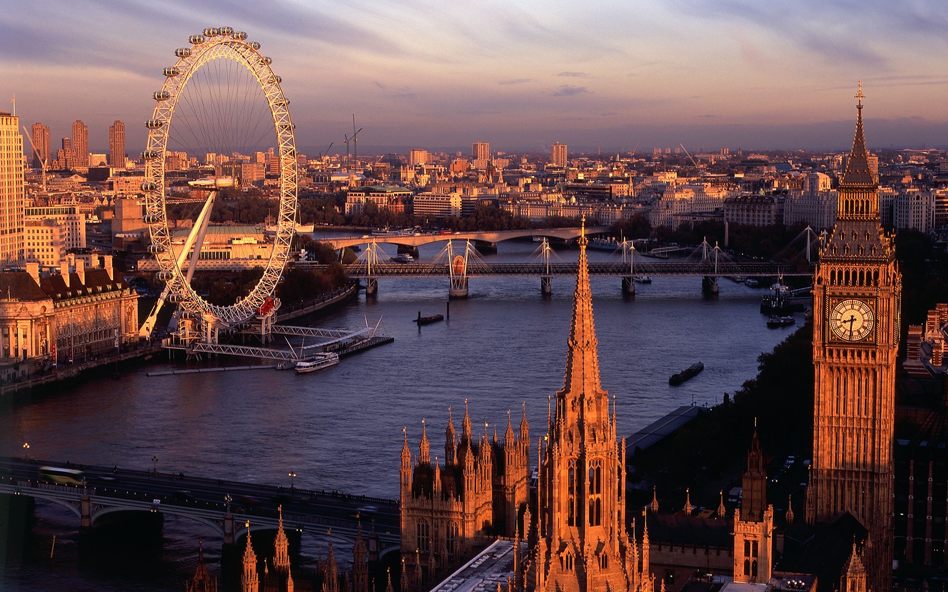 A stunning sunset view of the London skyline, featuring the London Eye, Big Ben, and the Houses of Parliament