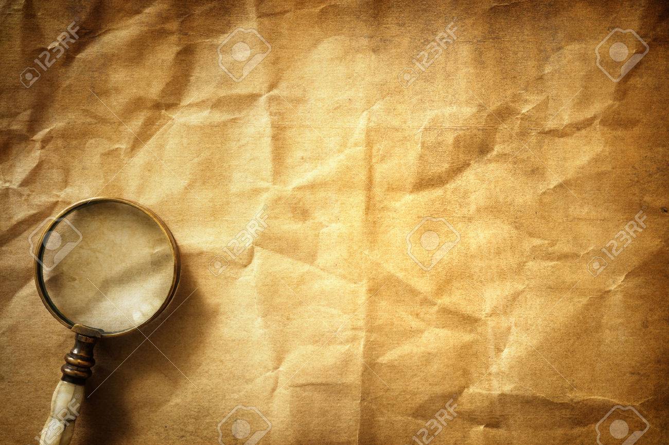 Vintage Magnifying Glass On Old Parchment Paper Background Stock