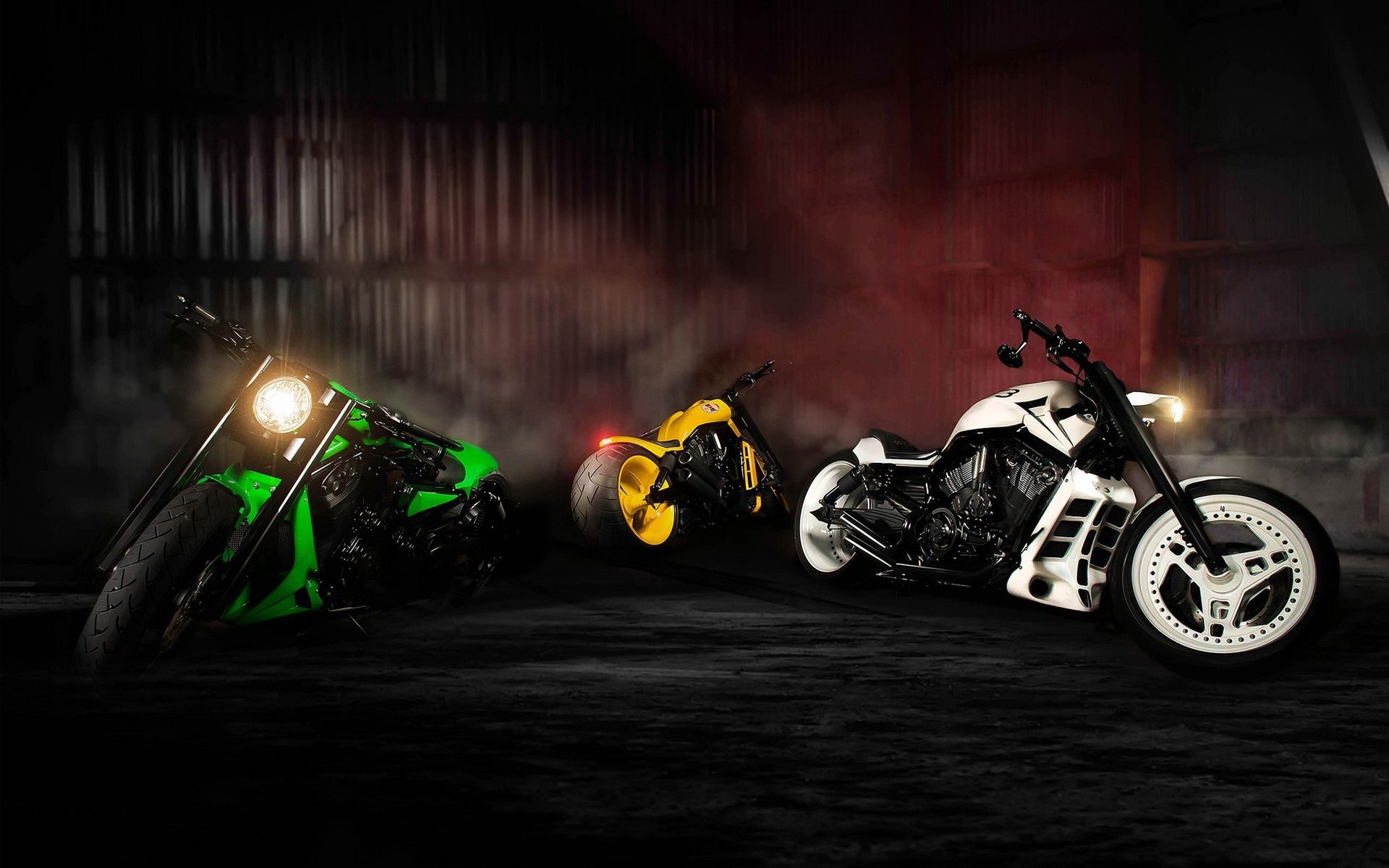 Three Custom Motorcycles in a Dark Setting