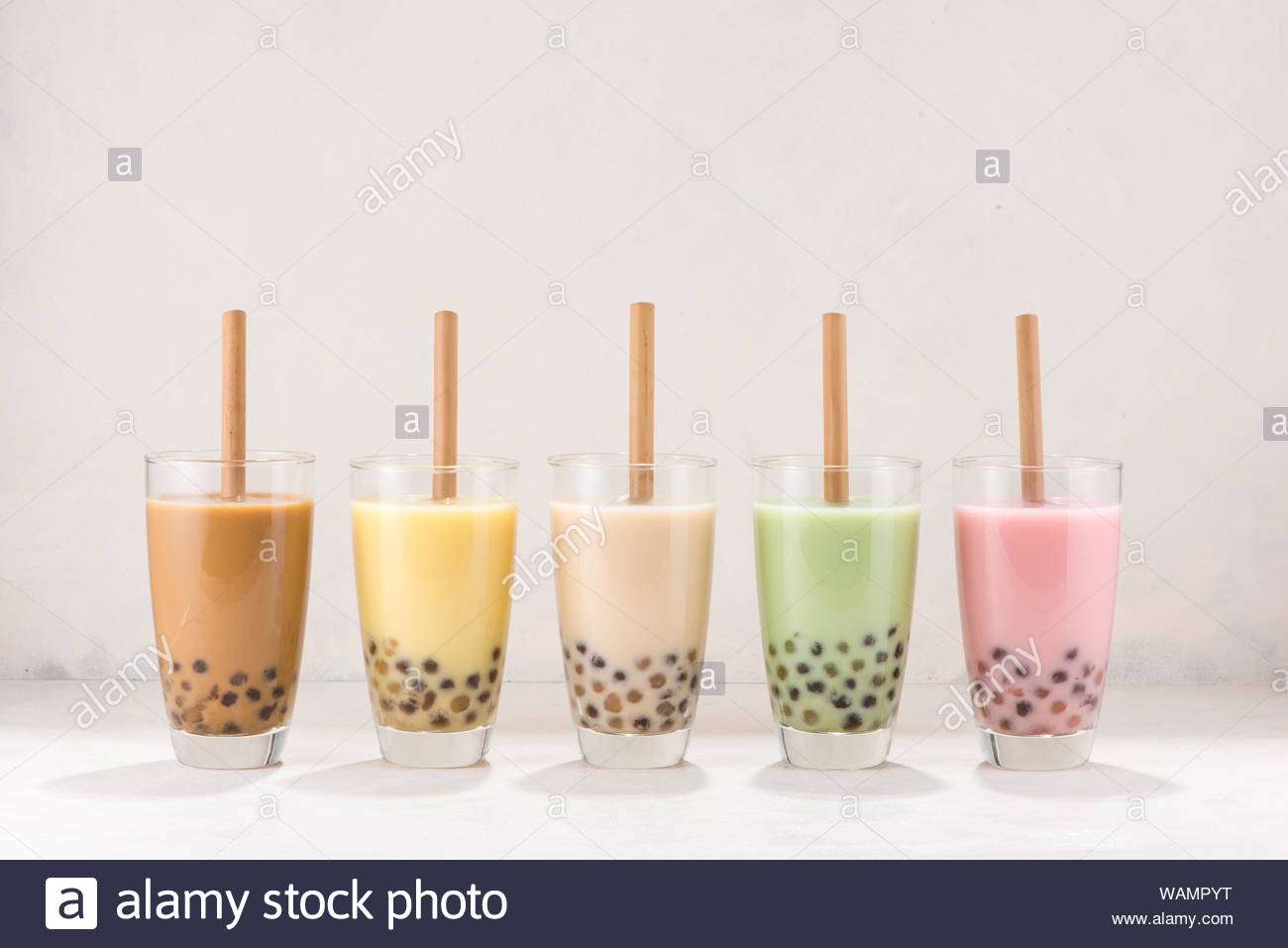 Row Of Fresh Boba Bubble Tea Glasses With Straw On White