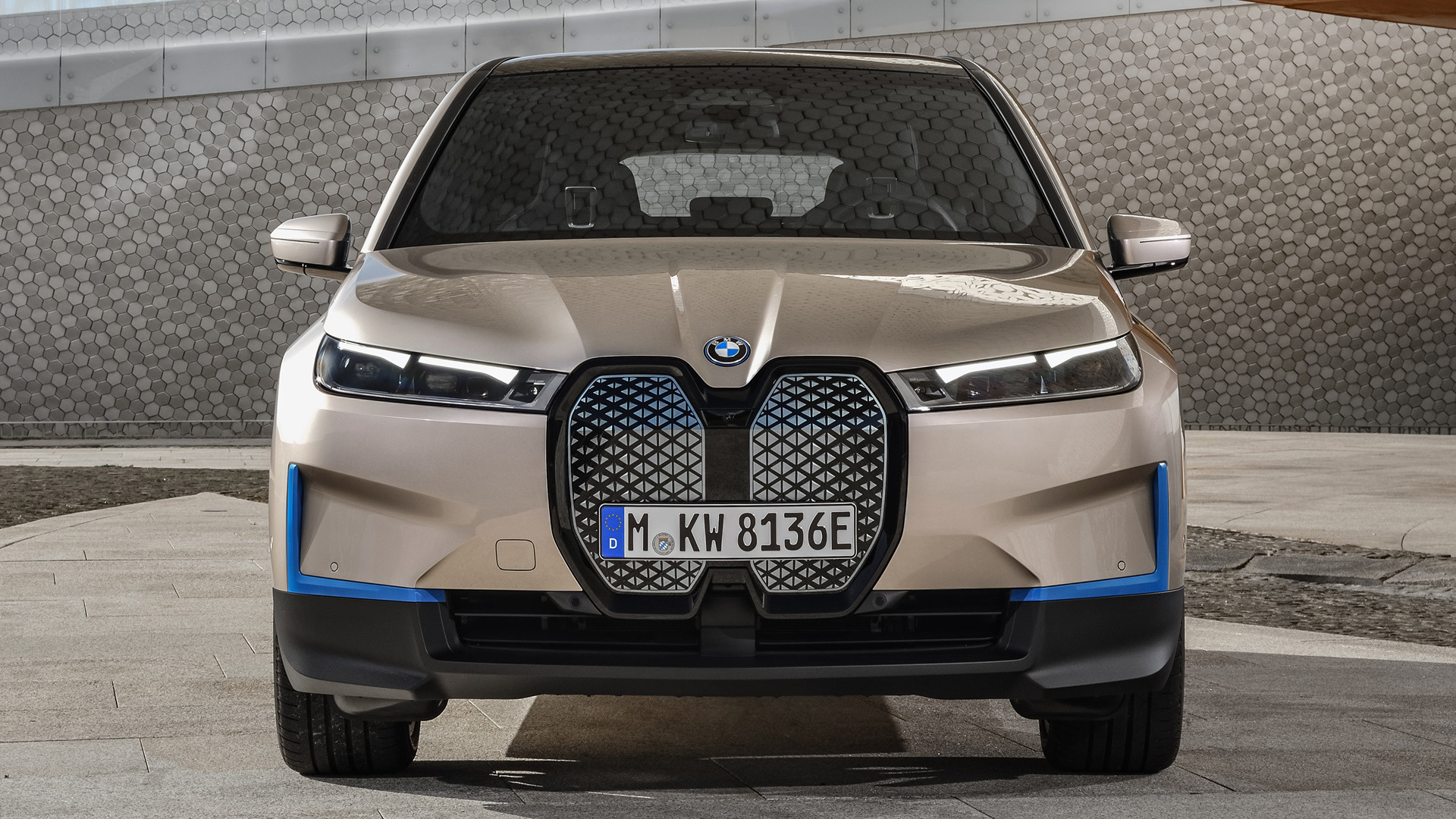 Front view of a BMW iX electric SUV, highlighting its unique grille design and futuristic aesthetics