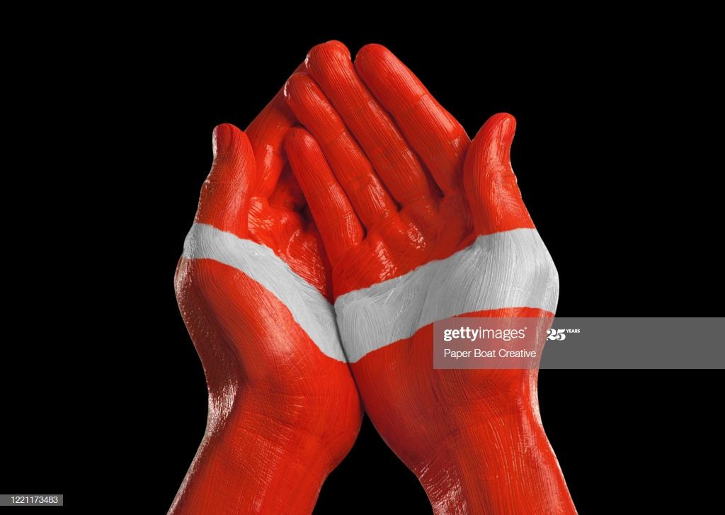 Cupped Hands On Black Background With Austrian Flag In