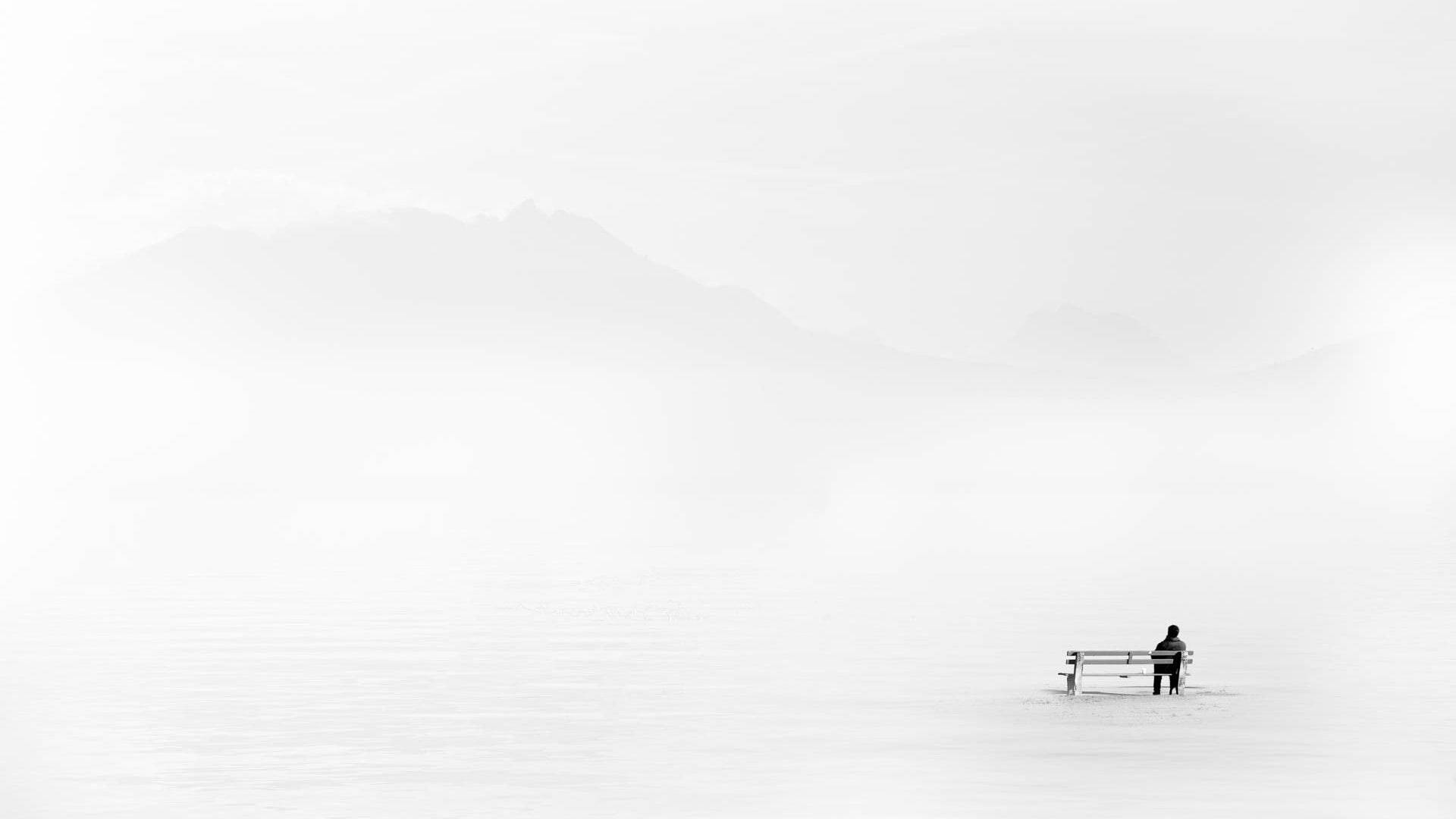 Minimalist Graphic Of Man Sitting Alone Wallpaper