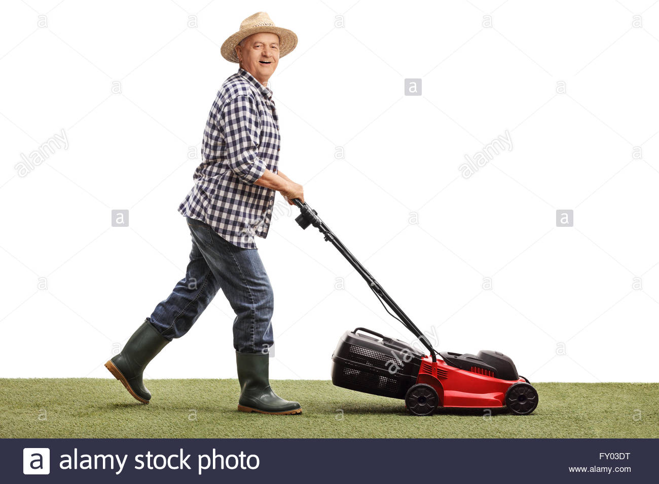 Profile Shot Of A Mature Man Mowing Lawn With Lawnmower