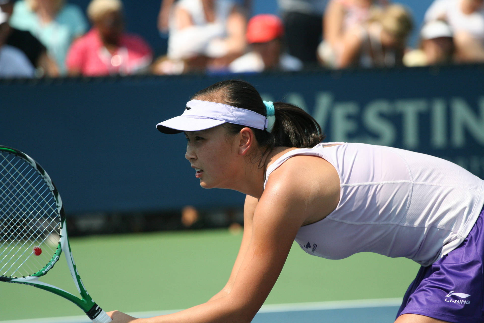 Shuai Peng Demonstrating Concentration And Agility In A Tennis Wallpaper