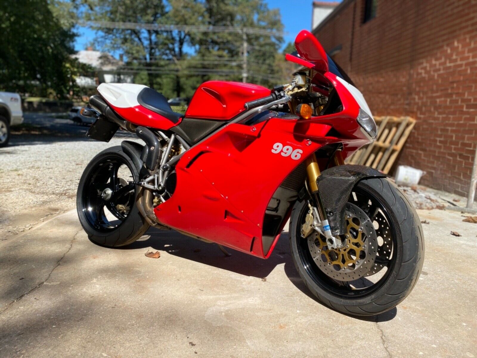 Ducati 996 sportbike parked in front of brick wall