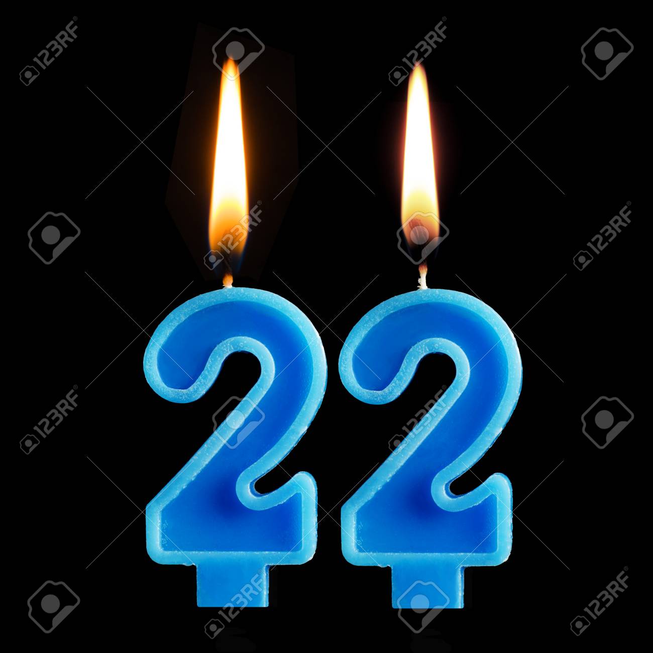 Burning Birthday Candles In The Form Of Twenty Two For Cake