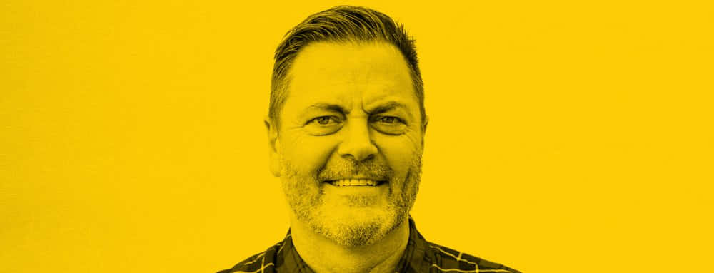 Renowned Actor Nick Offerman Posing With A Charismatic Smile Wallpaper