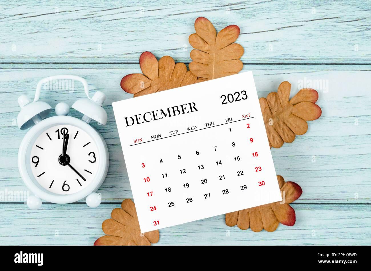 December Monthly Calendar Year And Alarm Clock With Dried