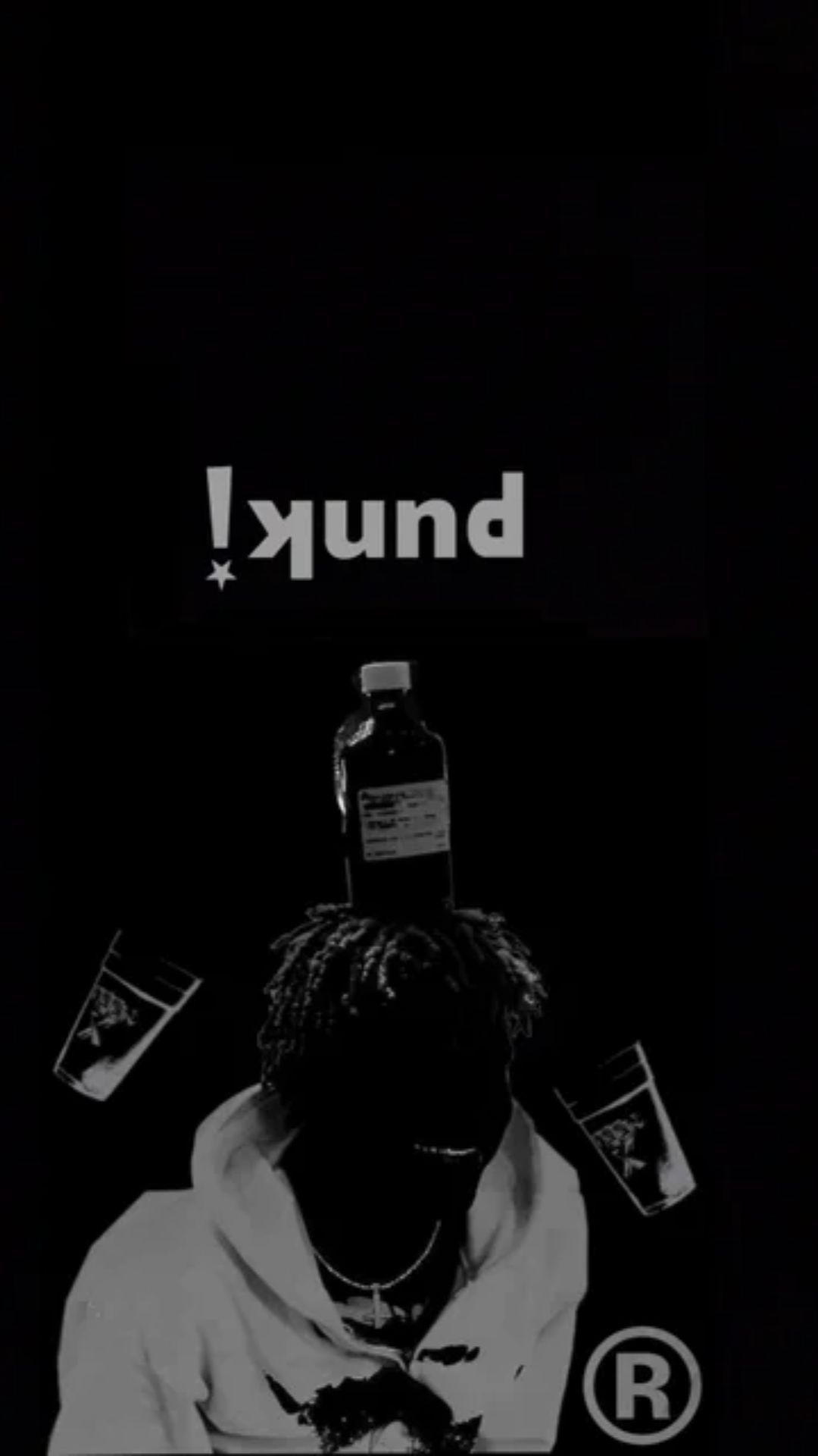 Ken Carson in black and white, with a bottle and cups surrounding his head, and his stage name displayed above