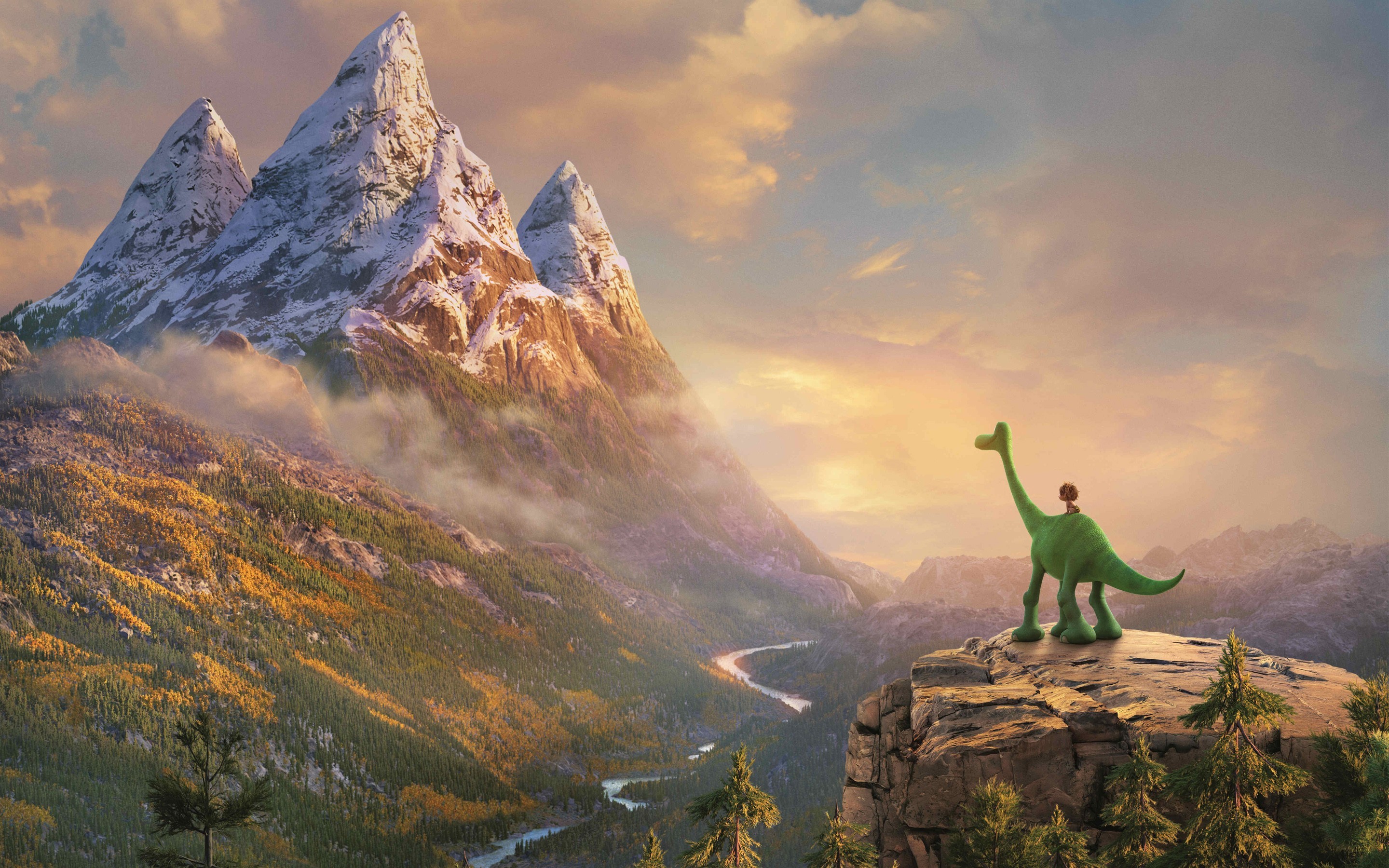 A cute green dinosaur with a small boy on its back standing on a cliff overlooking a majestic mountain valley landscape at sunset, from the animated movie The Good Dinosaur