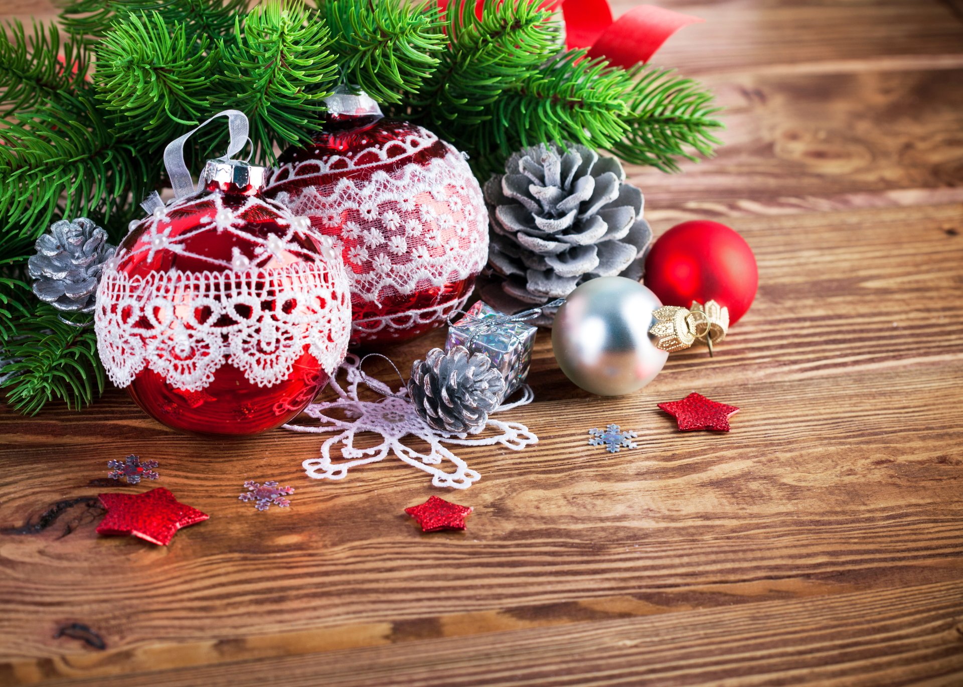 Christmas ornaments and decorations arranged on a wooden table, creating a festive and preppy holiday scene