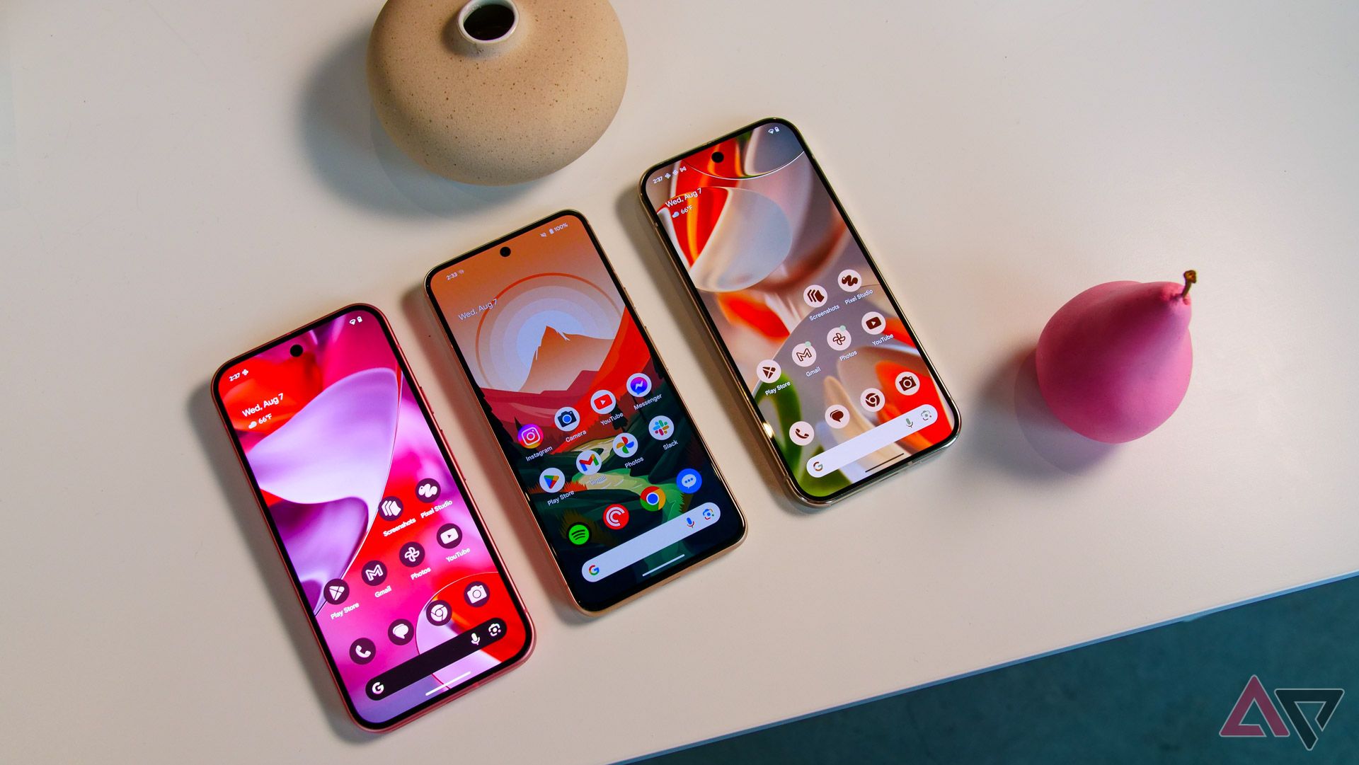 Three Google Pixel phones showcasing different color variations and home screen setups with Google Pixel 9 wallpapers
