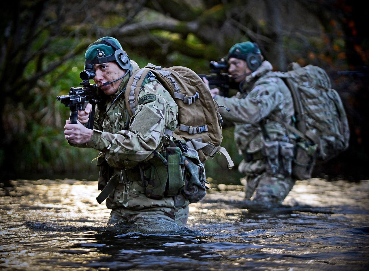 Two French Commandos Marine wading through a river during a military exercise