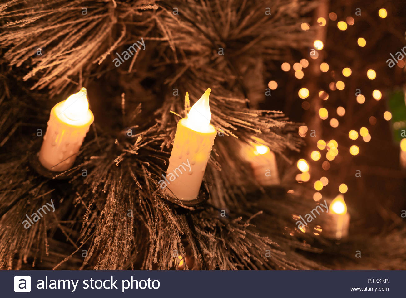 Traditional Candles On Flocked Christmas Tree With Glowing Lights