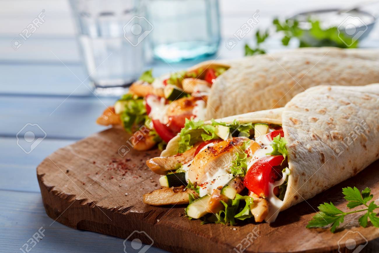 Two Healthy Tex Mex Tortilla Wraps Ed From Side On Wooden