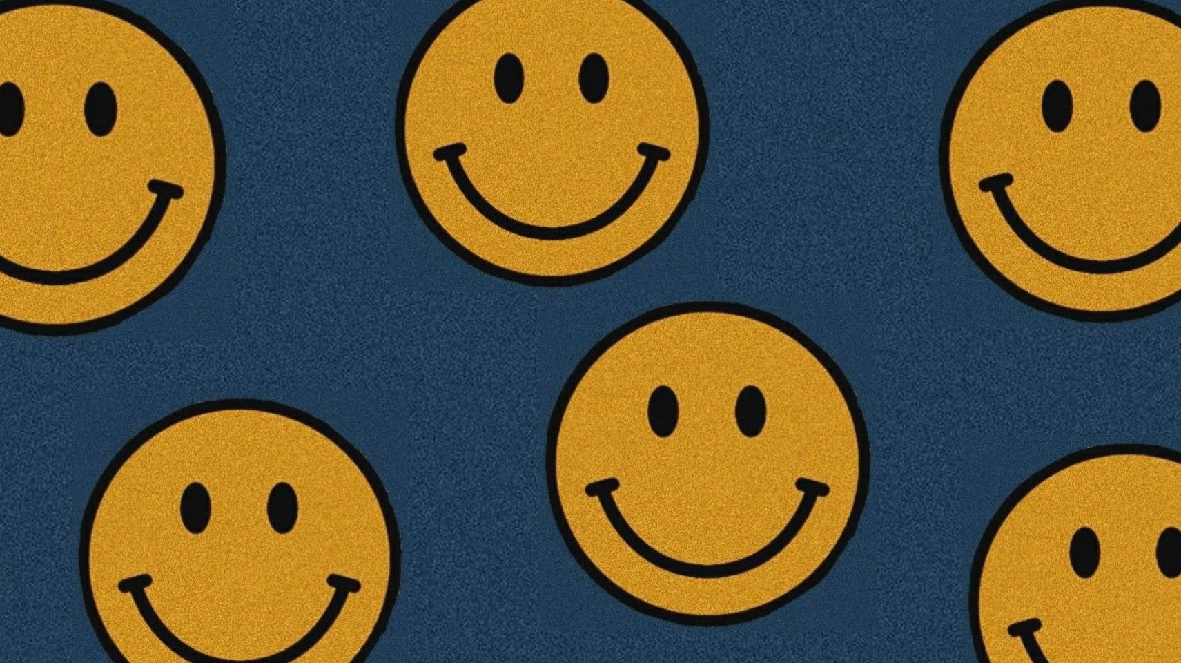 Classic yellow smiley faces on a textured dark blue background, perfect for a cheerful wallpaper