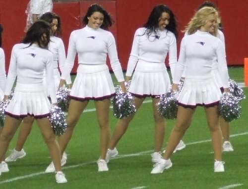 Five Smiling New England Patriots Cheerleaders Doing A Synchronized