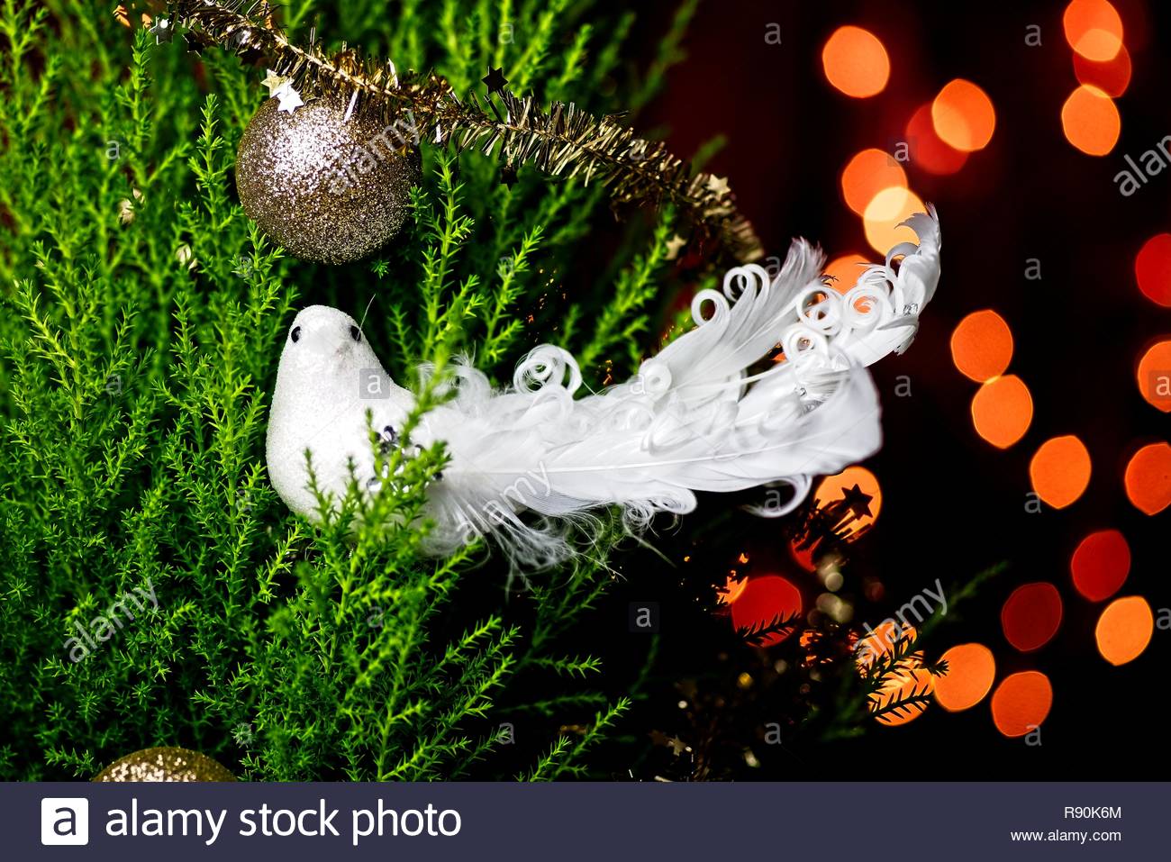 Christmas Scene With Bird On The Tree And Background Lights Stock