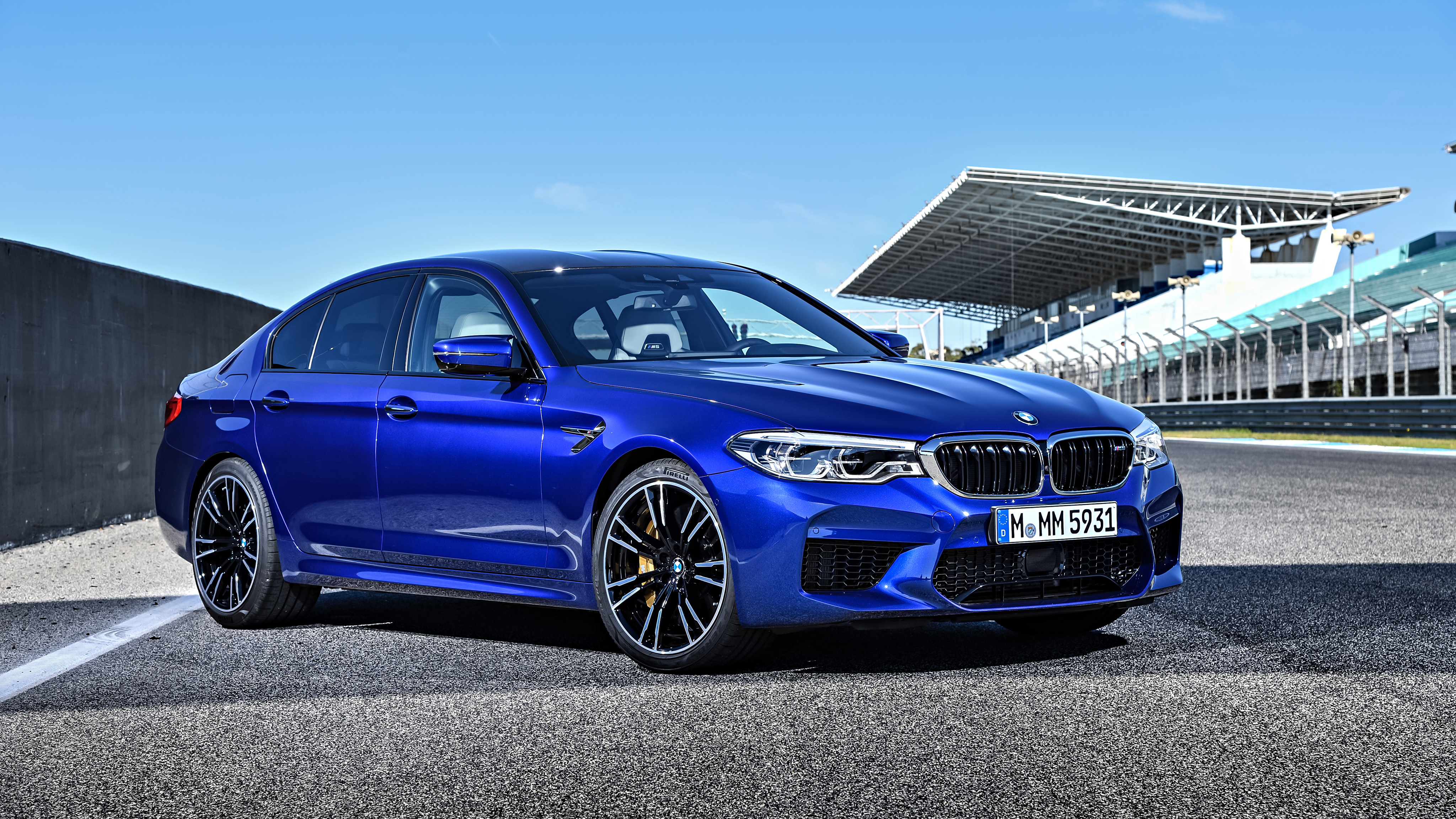 BMW M5 Sedan in Snapper Rocks Blue Metallic at a race track