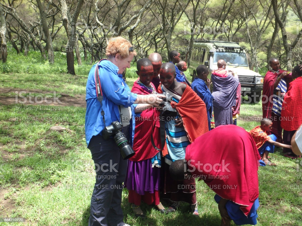 Tourist With Girls From Maasai Village Ngorongoro Conservation