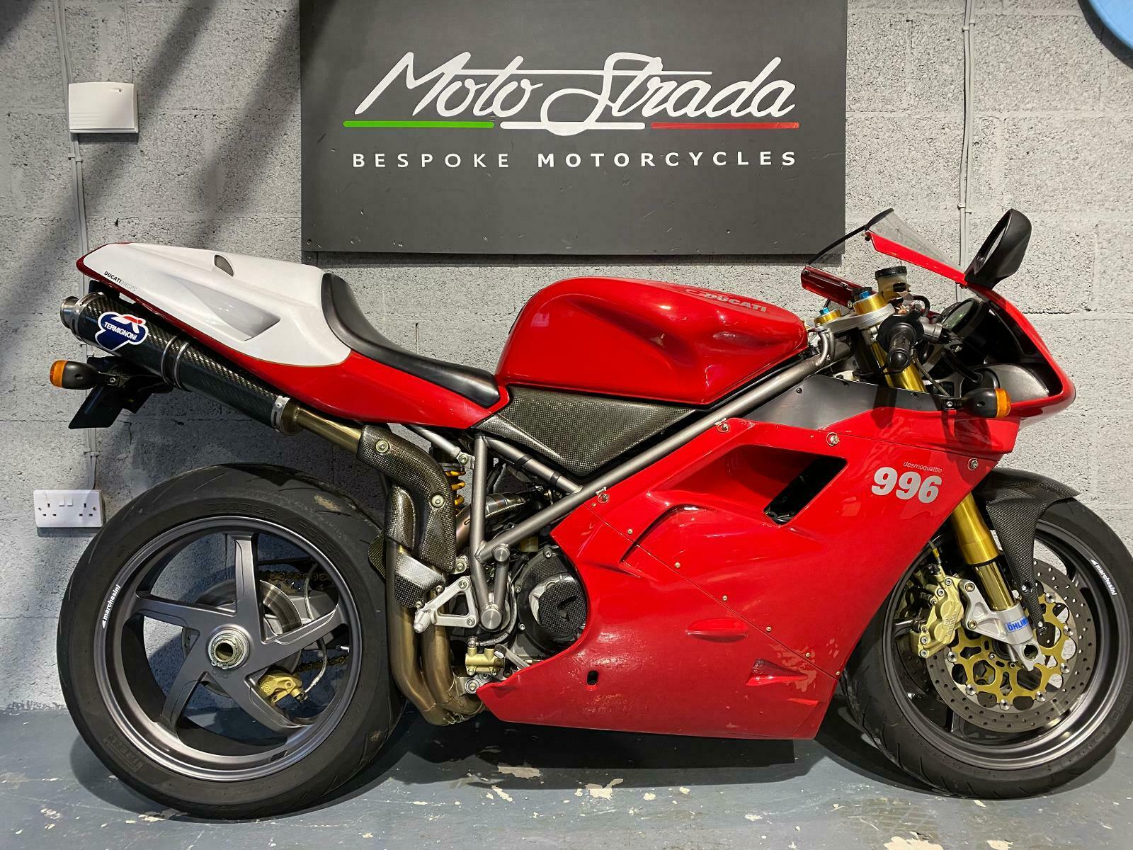 Red and white Ducati 996 motorcycle in a showroom