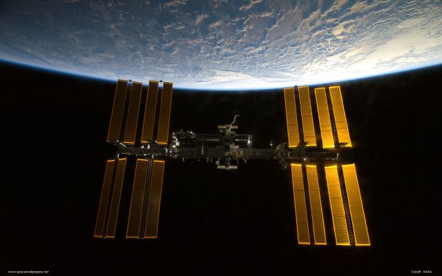 The International Space Station Back Dropped By Earth As Seen From