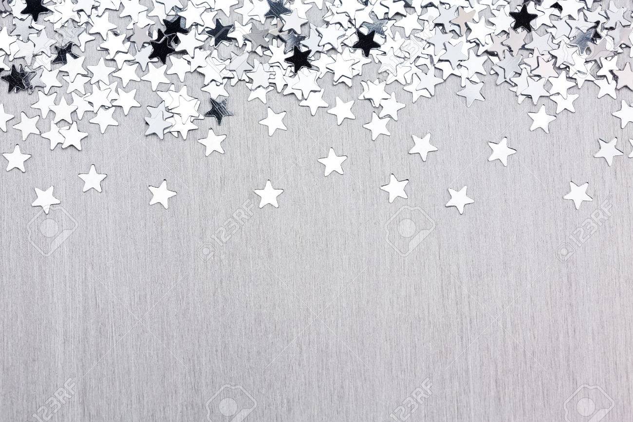 Christmas Background With Silver Star Confetti On Brushed Metal